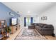 Cozy living room with a large sectional sofa, TV, and decorative shelving at 211 Duke Dr, Deland, FL 32724