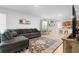 Spacious open concept living area with gray sectional couch, decor, and view of the dining and kitchen areas at 211 Duke Dr, Deland, FL 32724