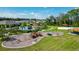 Community playground includes swings, slides, and shaded picnic areas with a pool, and homes in the background at 211 Duke Dr, Deland, FL 32724