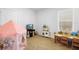Bright playroom with a table and chairs, toy kitchen, and play tent at 211 Duke Dr, Deland, FL 32724
