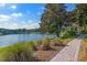Scenic view of a pond with a paved pathway and gazebo, perfect for leisurely strolls and enjoying nature at 211 Duke Dr, Deland, FL 32724