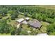 Wide aerial view of home with two garages surrounded by mature trees and landscaping at 226 Treeline Ln, Ormond Beach, FL 32174