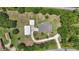 Expansive property with a home, two garages, circular driveway, and lush greenery at 226 Treeline Ln, Ormond Beach, FL 32174