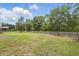 Large grassy backyard enclosed with wooden fencing, with various mature trees for natural privacy at 226 Treeline Ln, Ormond Beach, FL 32174