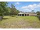 Vast lawn showcasing the home's screened-in porch and fenced perimeter at 226 Treeline Ln, Ormond Beach, FL 32174