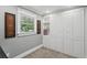 Neutral-toned bedroom with built-in storage, a window offering natural light, and gray carpeting at 226 Treeline Ln, Ormond Beach, FL 32174