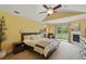 Bright bedroom with fireplace, ceiling fan, access to backyard, and yellow walls at 226 Treeline Ln, Ormond Beach, FL 32174
