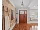 Stylish foyer featuring hardwood floors, brick accent wall, and a built-in bench at 226 Treeline Ln, Ormond Beach, FL 32174