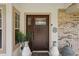 Elegant front door with decorative glass, surrounded by lush greenery and stylish decor at 226 Treeline Ln, Ormond Beach, FL 32174