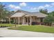 Charming brick home with manicured lawn, inviting entrance, and well-maintained landscaping at 226 Treeline Ln, Ormond Beach, FL 32174