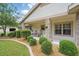 Inviting front porch with rocking chairs, lovely landscaping, and brick-accented columns at 226 Treeline Ln, Ormond Beach, FL 32174