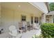 Cozy front porch with seating, great natural light, and well-manicured greenery at 226 Treeline Ln, Ormond Beach, FL 32174