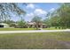 Inviting single-story home featuring a circular driveway and a manicured front lawn at 226 Treeline Ln, Ormond Beach, FL 32174