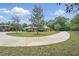 Beautiful home with a winding driveway, lush lawn, and a picturesque tree-lined landscape at 226 Treeline Ln, Ormond Beach, FL 32174