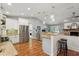 Well-lit kitchen featuring granite countertops, stainless steel appliances, and a breakfast bar at 226 Treeline Ln, Ormond Beach, FL 32174