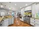 Modern kitchen with stainless steel appliances, granite countertops, and hardwood floors at 226 Treeline Ln, Ormond Beach, FL 32174