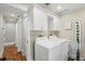 Laundry room with white cabinets and modern washer/dryer at 226 Treeline Ln, Ormond Beach, FL 32174