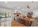 Comfortable living room with fireplace, hardwood floors, large windows, and leather furniture at 226 Treeline Ln, Ormond Beach, FL 32174
