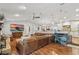 Open-concept living area featuring a large leather sofa, wood floors, and vaulted ceilings at 226 Treeline Ln, Ormond Beach, FL 32174