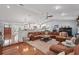 Open-concept living area with hardwood floors, a leather sectional, and views into the kitchen at 226 Treeline Ln, Ormond Beach, FL 32174