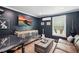 Stylish living room featuring dark walls, modern furnishings, and a TV for entertainment at 226 Treeline Ln, Ormond Beach, FL 32174