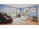 Bright office space with blue walls, a massage chair, a white desk, and windows offering natural light at 226 Treeline Ln, Ormond Beach, FL 32174