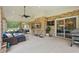 Spacious outdoor patio with brick accents, lounge seating, and a view of the landscaped backyard at 226 Treeline Ln, Ormond Beach, FL 32174