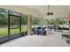 Screened patio with brick columns, a seating area, dining set and view of the fenced backyard at 226 Treeline Ln, Ormond Beach, FL 32174