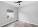 Neutral bedroom featuring wood-look flooring, a large window and plenty of natural light at 2379 8Th Ave, Deland, FL 32724