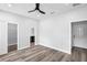 Spacious bedroom with modern ceiling fan and wood-look flooring, leading to ensuite bathroom at 2379 8Th Ave, Deland, FL 32724