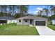 Well-maintained single-story home with a manicured lawn and attached garage at 2379 8Th Ave, Deland, FL 32724