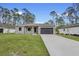 Charming one-story home with a gray exterior, spacious driveway, and well-manicured lawn at 2379 8Th Ave, Deland, FL 32724