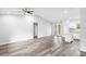 Bright, airy living room adjacent to kitchen, featuring vaulted ceiling and outdoor access at 2379 8Th Ave, Deland, FL 32724