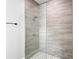 Modern shower with glass enclosure and decorative stone flooring at 2379 8Th Ave, Deland, FL 32724