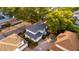 An aerial view of a home with a new roof, a brick paved driveway, and is surrounded by beautiful trees at 2418 Formosa Ave, Orlando, FL 32804