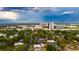 An aerial view showing the neighborhood with tree-lined streets, surrounded by city buildings at 2418 Formosa Ave, Orlando, FL 32804