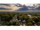 A picturesque aerial view of a neighborhood with lush green trees and houses nestled amongst them at 2418 Formosa Ave, Orlando, FL 32804
