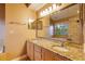 The bathroom features double sinks, granite countertops, and a large mirror at 2418 Formosa Ave, Orlando, FL 32804