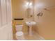 The bathroom features a pedestal sink, toilet, tile floors, and neutral colored walls at 2418 Formosa Ave, Orlando, FL 32804