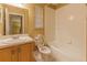 A bright bathroom with a sink vanity, toilet, and a bathtub-shower combo with white tile at 2418 Formosa Ave, Orlando, FL 32804