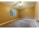 Cozy bedroom with a neutral color palette, carpet flooring, ceiling fan, and a window view at 2418 Formosa Ave, Orlando, FL 32804