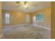 The bedroom features three windows, neutral colored walls, and carpeted floors at 2418 Formosa Ave, Orlando, FL 32804