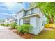 Two-story house with neutral paint, lush landscaping, brick driveway, and inviting curb appeal at 2418 Formosa Ave, Orlando, FL 32804