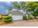 A two-story home with a two car garage and a brick paver driveway at 2418 Formosa Ave, Orlando, FL 32804