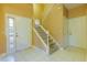 Tiled foyer featuring a staircase leading upstairs and two white doors at 2418 Formosa Ave, Orlando, FL 32804