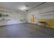 A garage with shelving, a work bench, and a door that leads to the interior of the home at 2418 Formosa Ave, Orlando, FL 32804