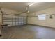 Spacious garage with overhead door, concrete floor, and window letting in natural light at 2418 Formosa Ave, Orlando, FL 32804