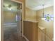 Bright hallway with decorative window, chandelier, and open door to carpeted bedroom at 2418 Formosa Ave, Orlando, FL 32804