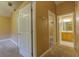 The hallway features carpeted floors, neutral walls, and two linen closets at 2418 Formosa Ave, Orlando, FL 32804