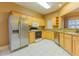 Functional kitchen with stainless steel appliances, light wood cabinets, and granite countertops at 2418 Formosa Ave, Orlando, FL 32804